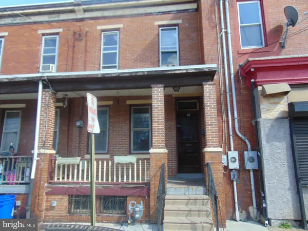 front view of a brick house with a small window