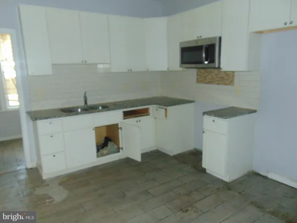 a kitchen with a sink and cabinets