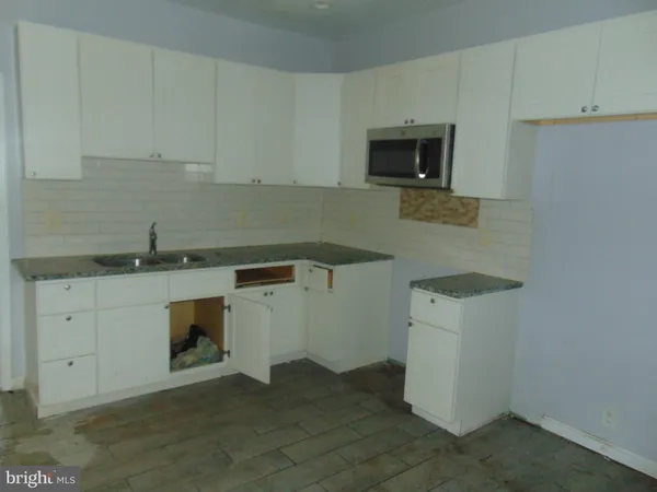 a kitchen with a sink and a stove