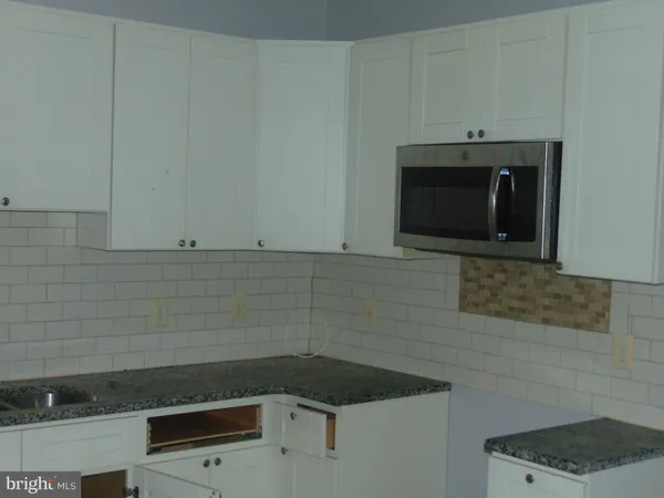 a bathroom with a sink and a microwave