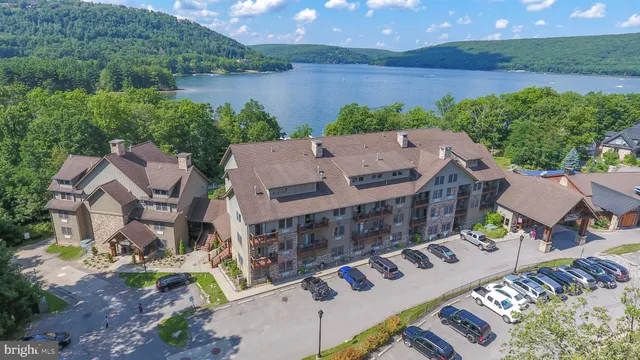 an aerial view of a house with outdoor space and lake view