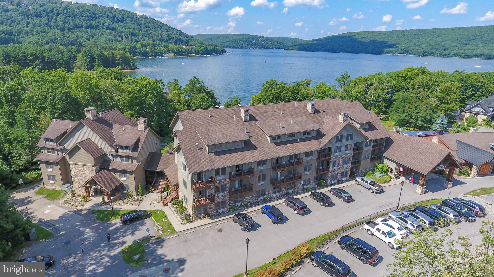 an aerial view of a house with outdoor space and lake view
