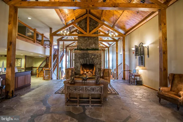 a living room with furniture a fireplace and gym equipment