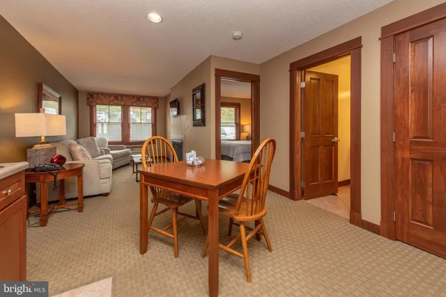 a view of a dining room with furniture and a window