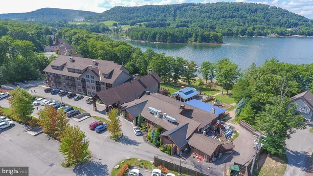 an aerial view of house with outdoor space and lake view