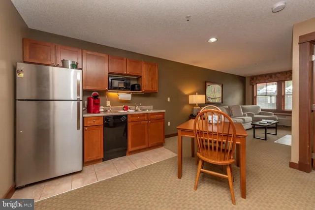 a kitchen with furniture a refrigerator and a sink