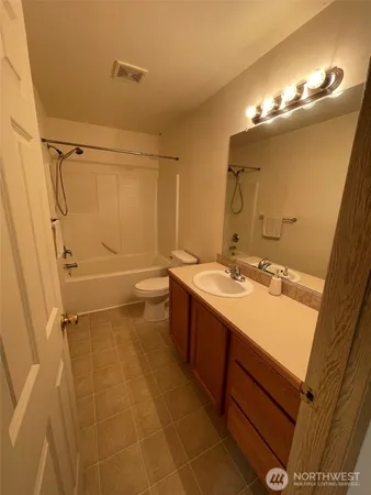 a bathroom with a double vanity sink mirror and shower
