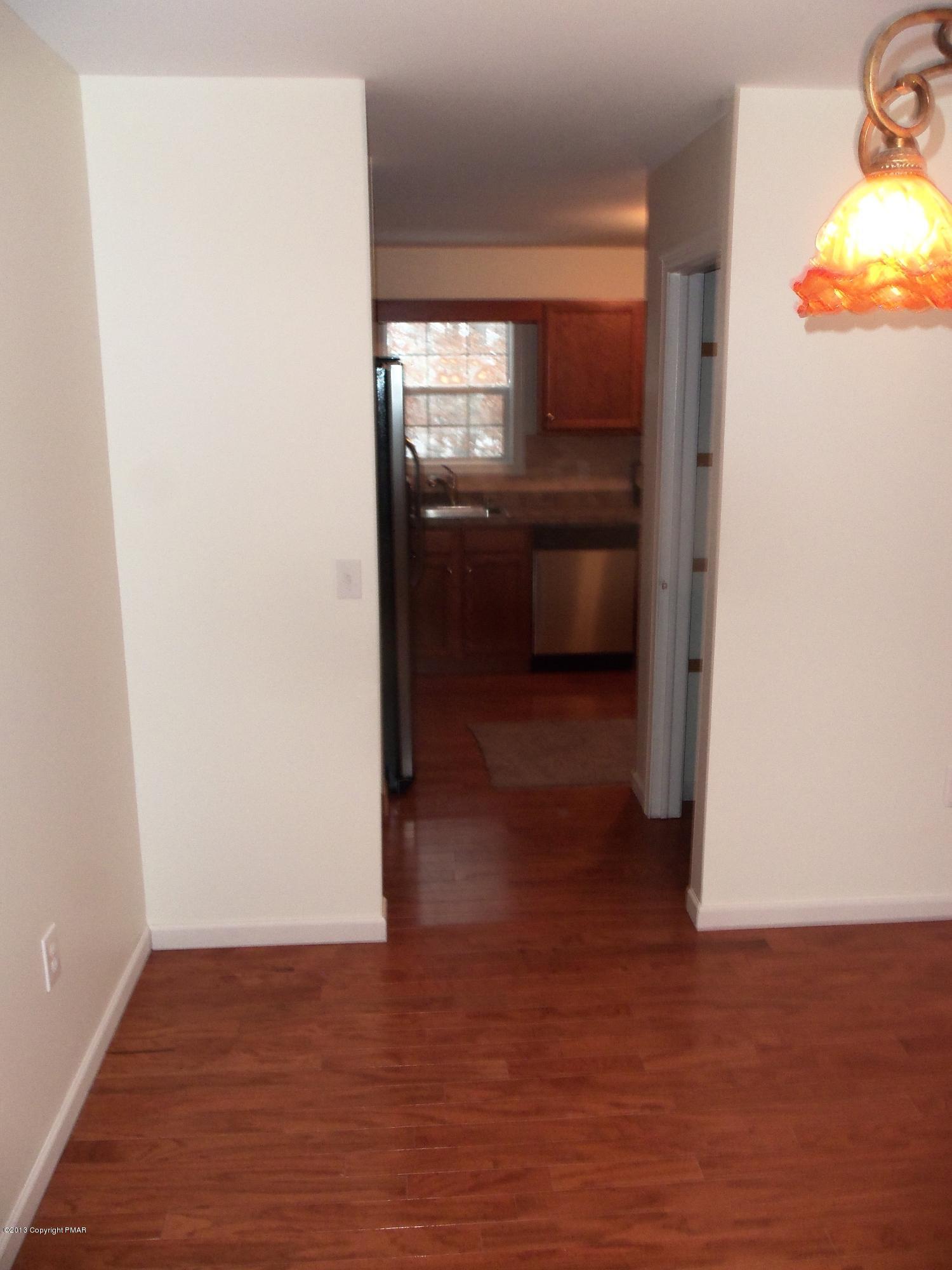 4153 Romeo Road Tobyhanna, PA 18466 - Photo 13 of 41 a view of a refrigerator in kitchen and an empty room