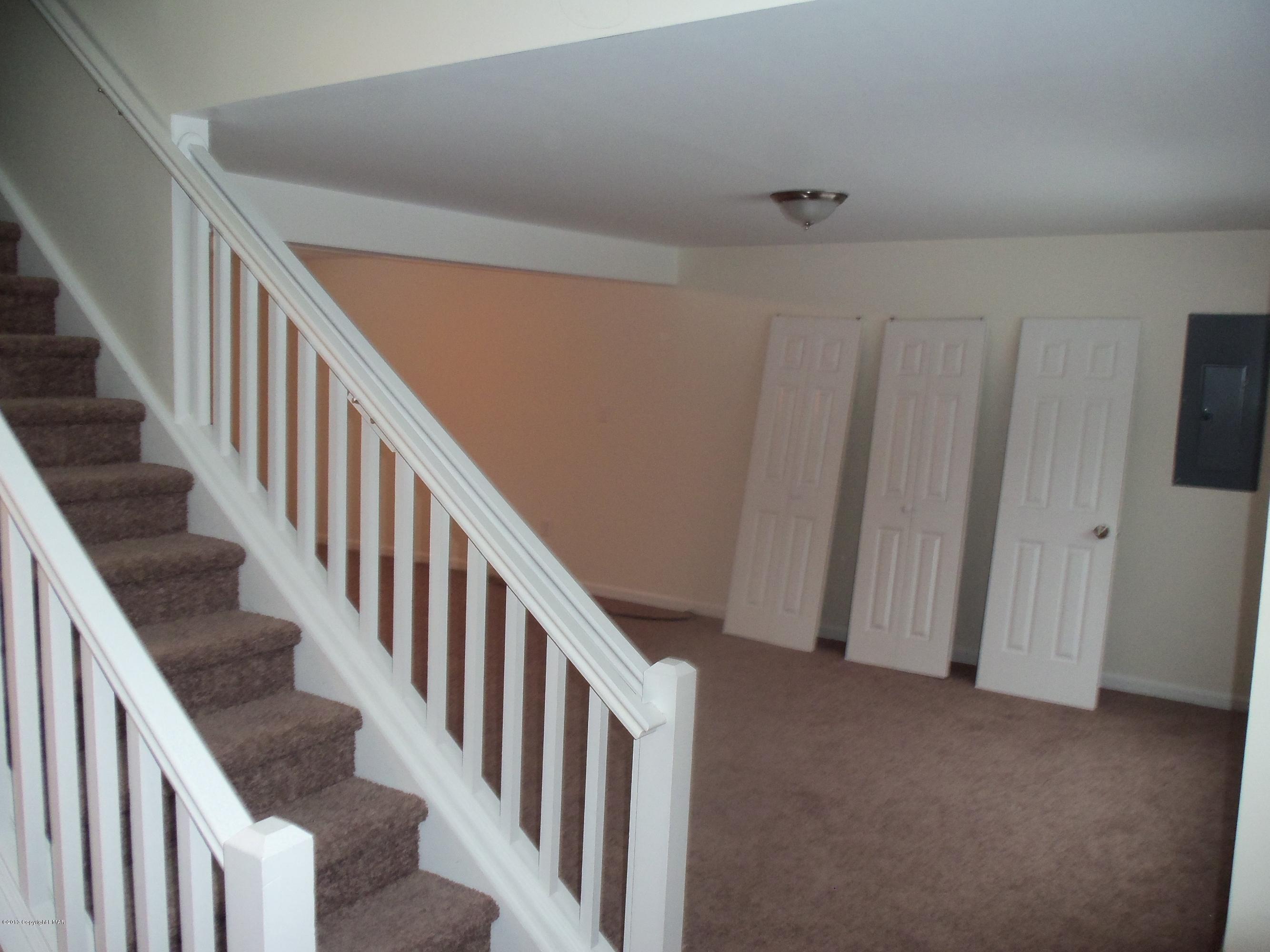 4153 Romeo Road Tobyhanna, PA 18466 - Photo 19 of 41 a view of staircase with lots of frames on wall and a window