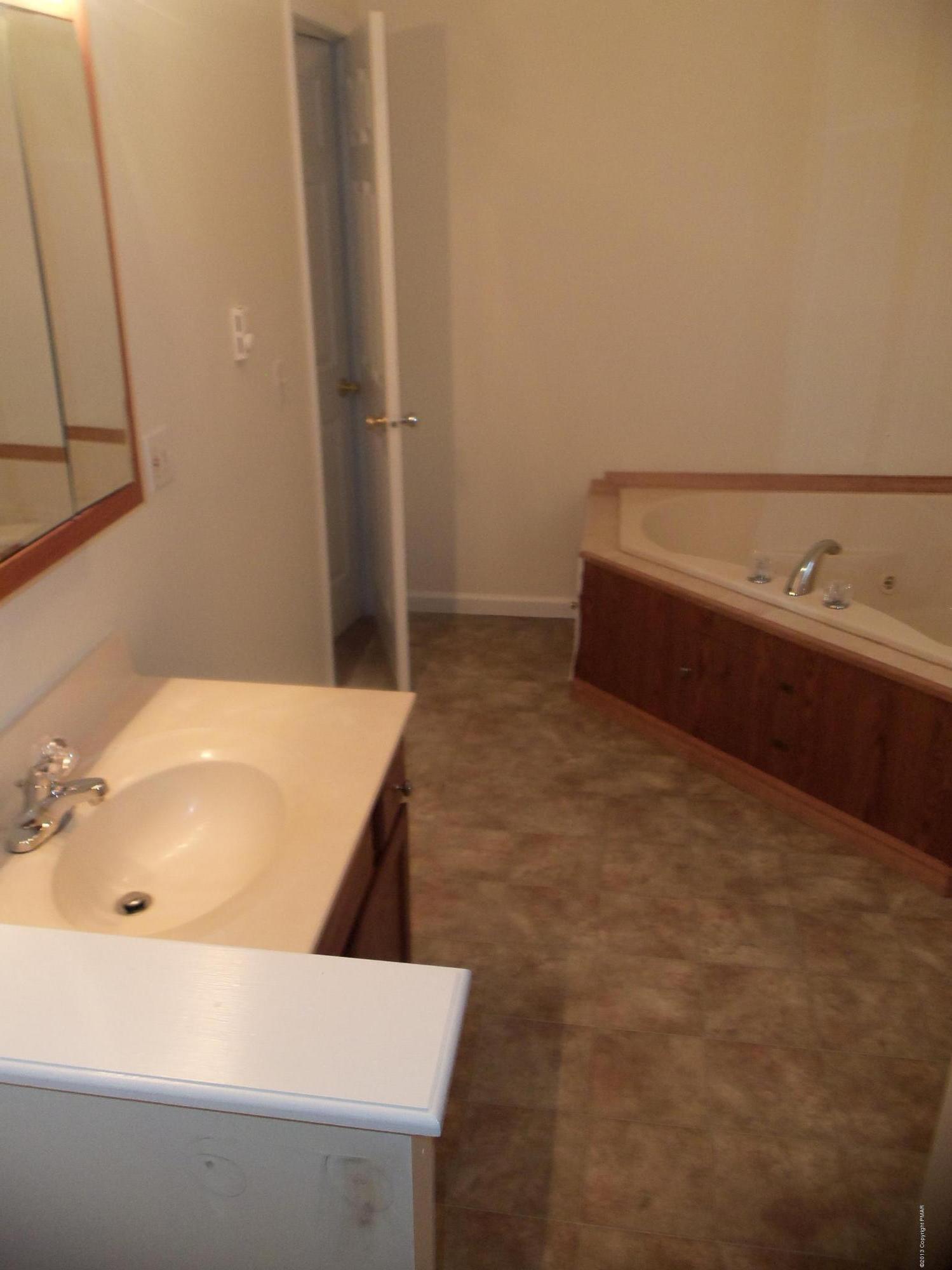4153 Romeo Road Tobyhanna, PA 18466 - Photo 38 of 41 a bathroom with a tub sink and mirror