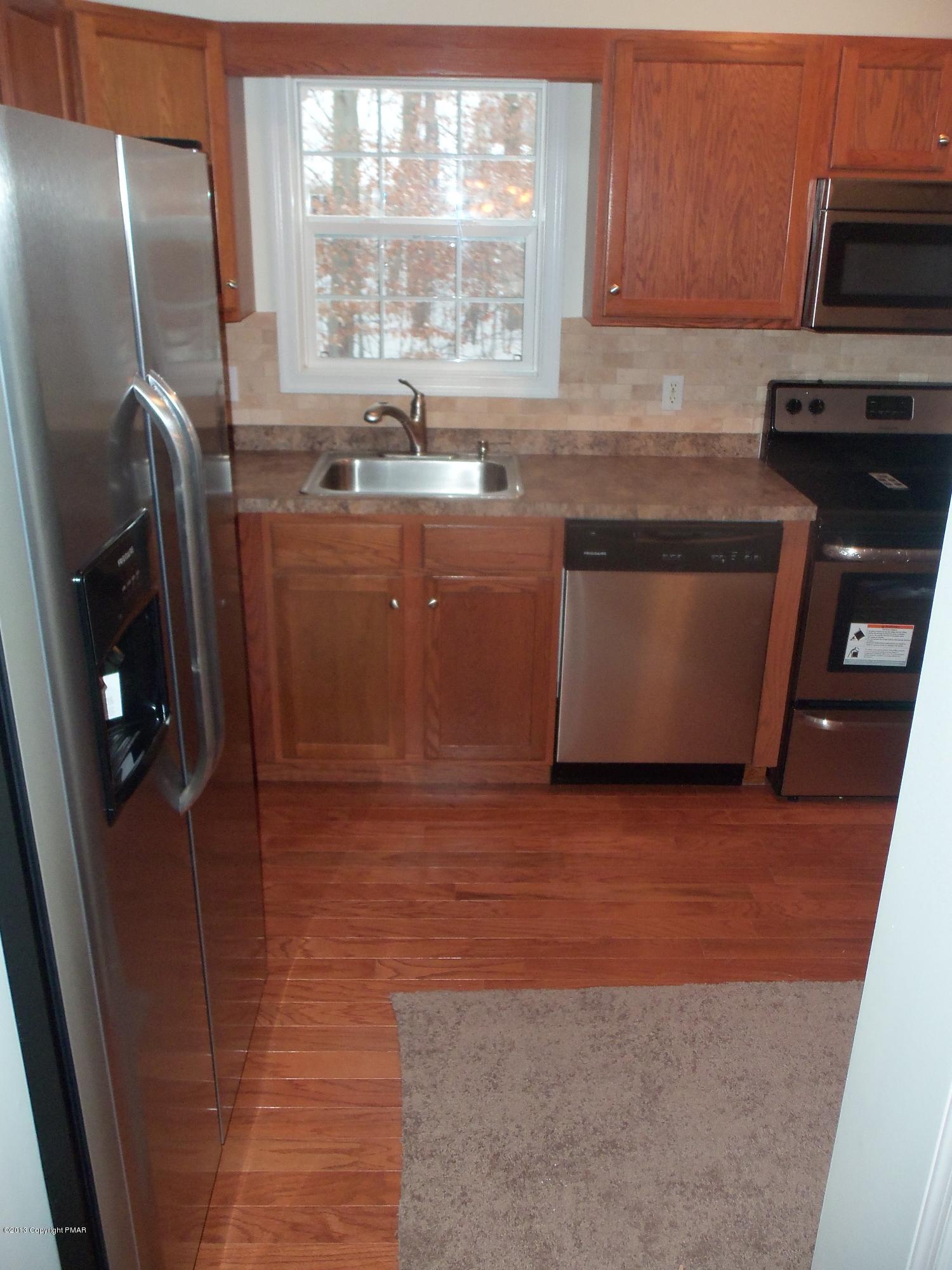 4153 Romeo Road Tobyhanna, PA 18466 - Photo 8 of 41 a kitchen with stainless steel appliances granite countertop a sink a stove a microwave a refrigerator and cabinets