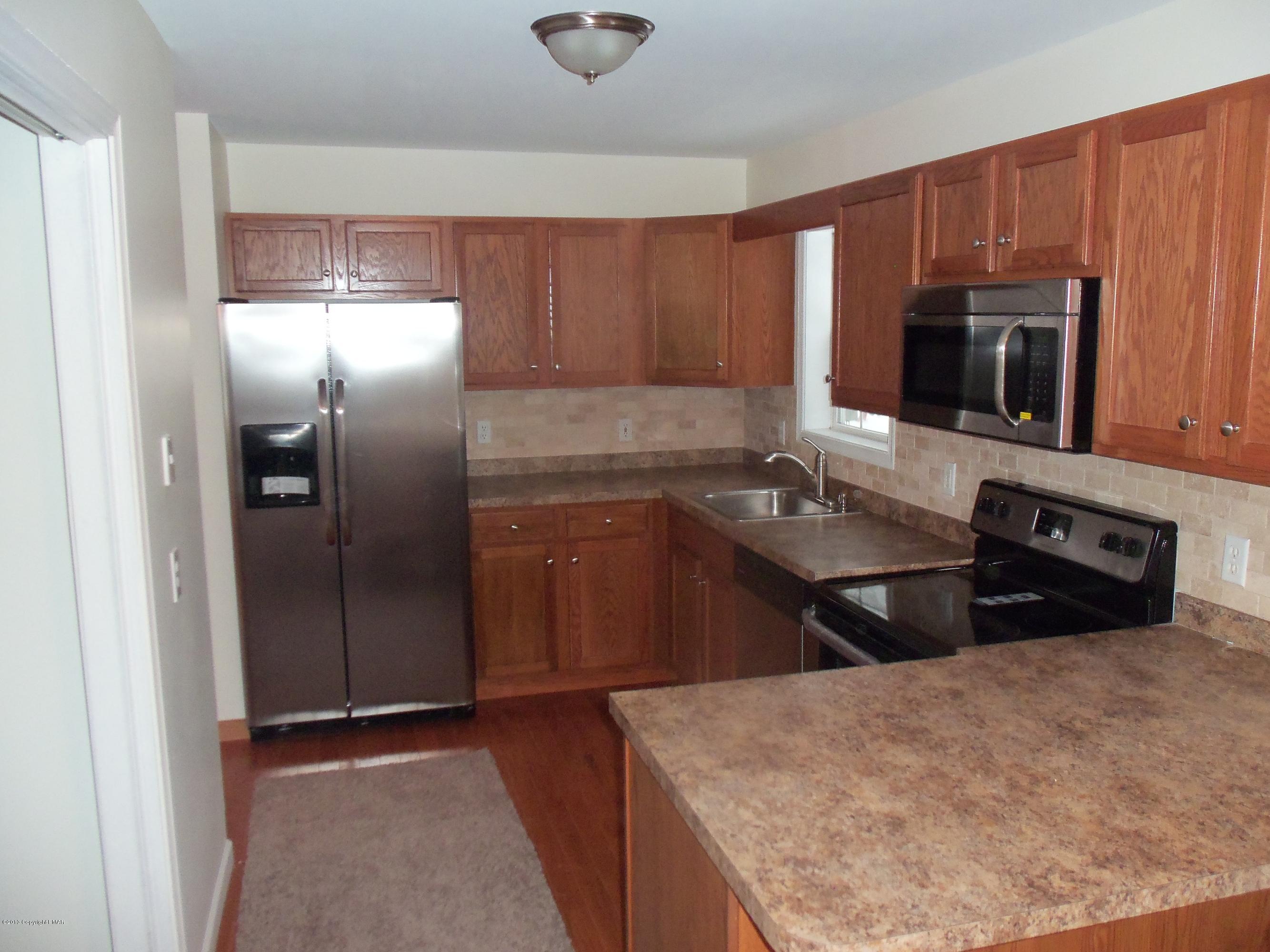 4153 Romeo Road Tobyhanna, PA 18466 - Photo 10 of 41 a kitchen with stainless steel appliances granite countertop a sink stove and refrigerator