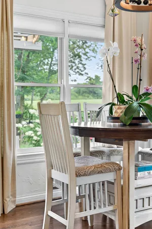 a view of a living room with a floor to ceiling window and wooden floor