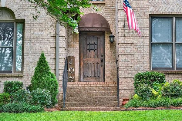 a front view of a house with garden
