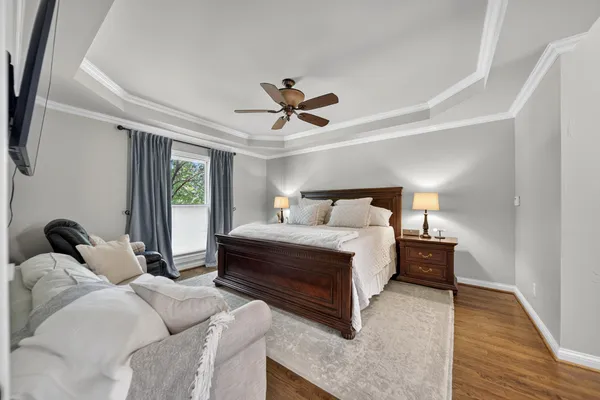 a bed room with a bed and a ceiling fan