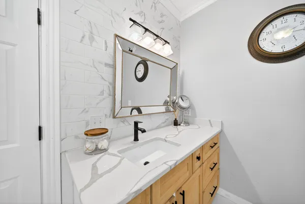 a bathroom with a sink and a mirror