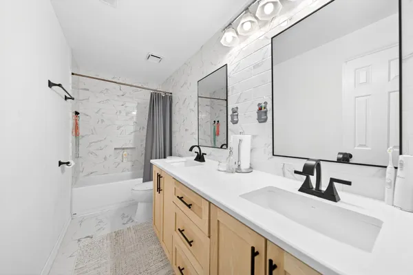 a bathroom with a sink double vanity shower and a mirror