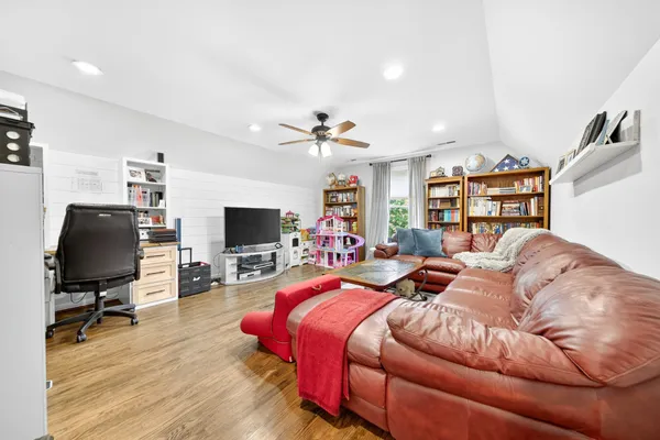 a living room with lots of furniture and wooden floor