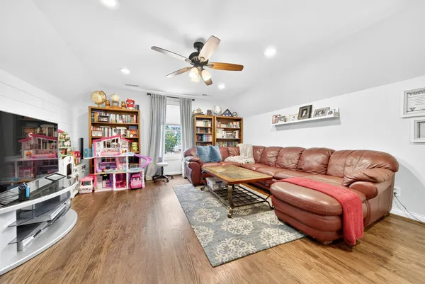 a view of a workspace with furniture and wooden floor