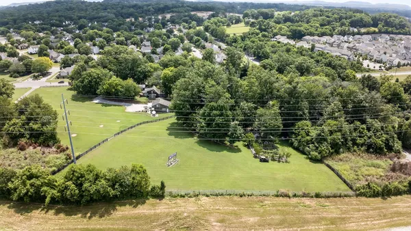 a backyard of a house with lots of green space and a fountain