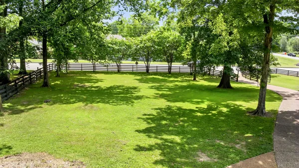 a backyard of a house with table and chairs