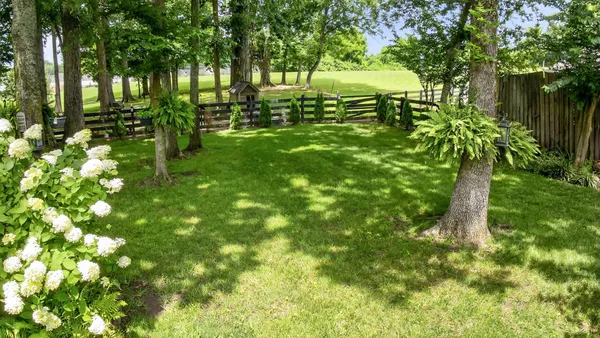 a view of a chair and table in backyard of the house