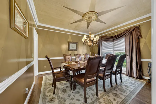 a view of a dining room with furniture and window