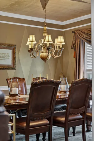 a view of a dining room with furniture and chandelier