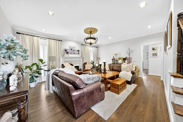 a living room with furniture potted plant floor and a large window