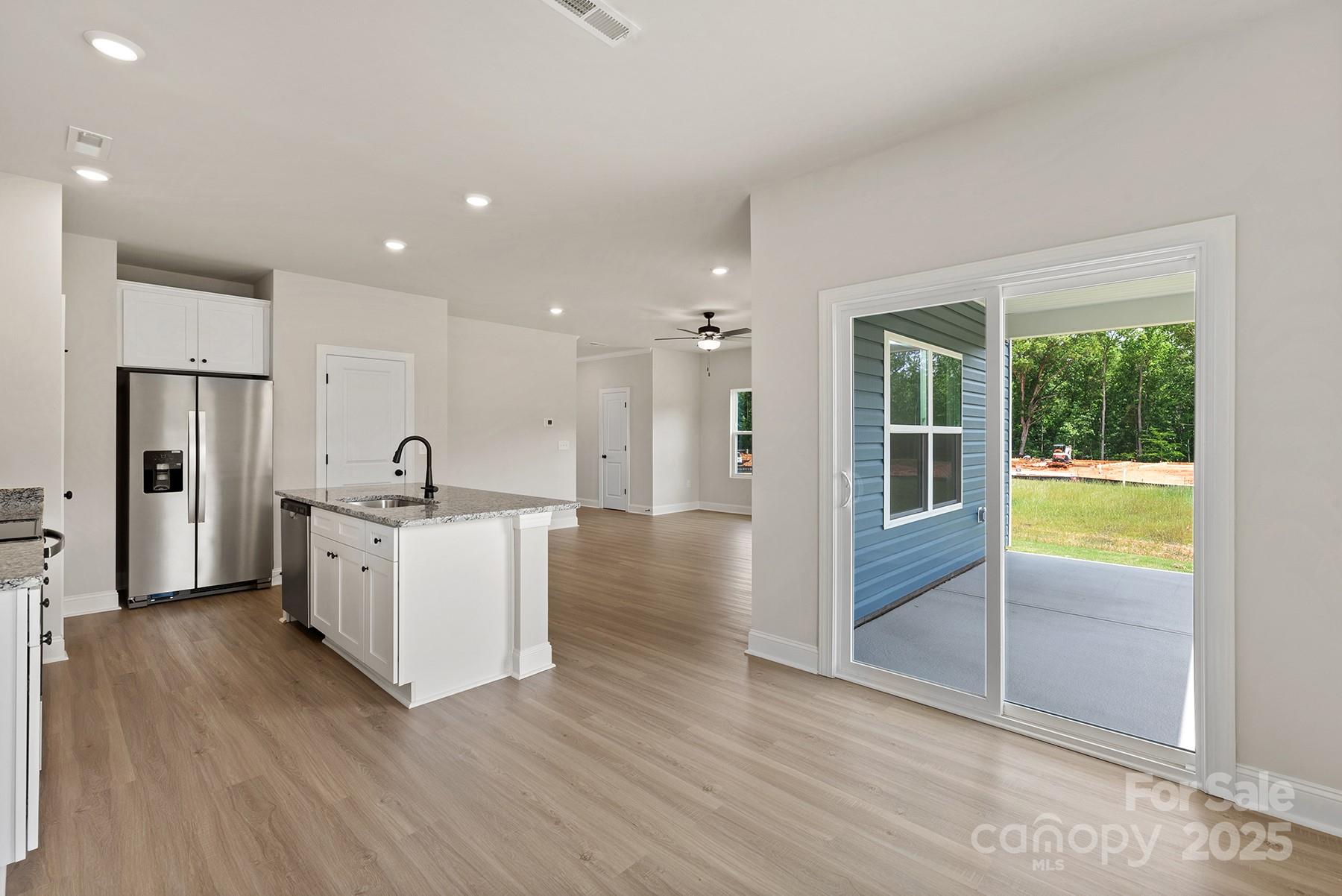 7117 Jerimoth Drive Charlotte, NC 28215 - Photo 10 of 12 a view of kitchen with stainless steel appliances granite countertop a stove top oven a refrigerator a sink and a large window