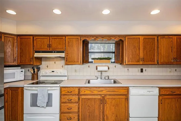 a kitchen that has a sink and a stove in it
