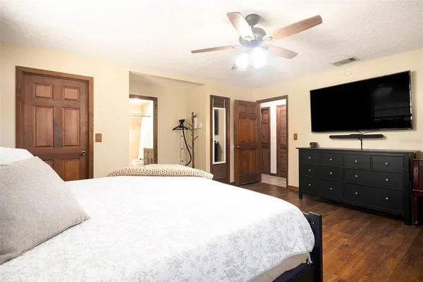 a bedroom with a bed and a flat screen tv