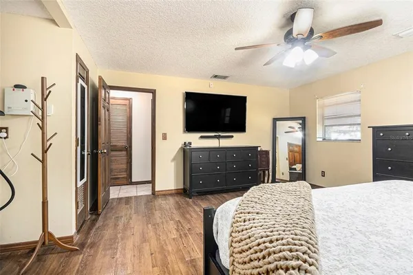 a bedroom with a bed and a flat screen tv