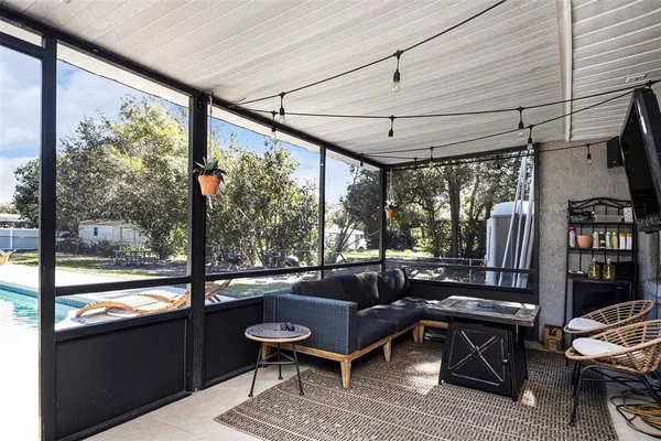 a outdoor living space with furniture and a rug
