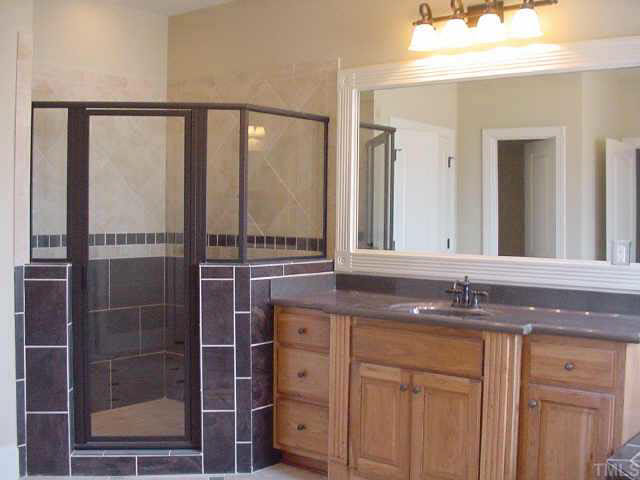 406 Waterville Street Raleigh, NC 27603 - Photo 7 of 10 a bathroom with a granite countertop sink and a mirror