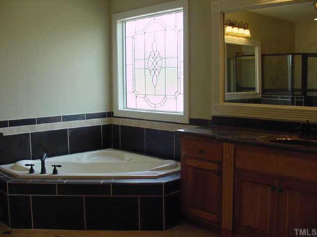 406 Waterville Street Raleigh, NC 27603 - Photo 8 of 10 a bathroom with a sink and a mirror