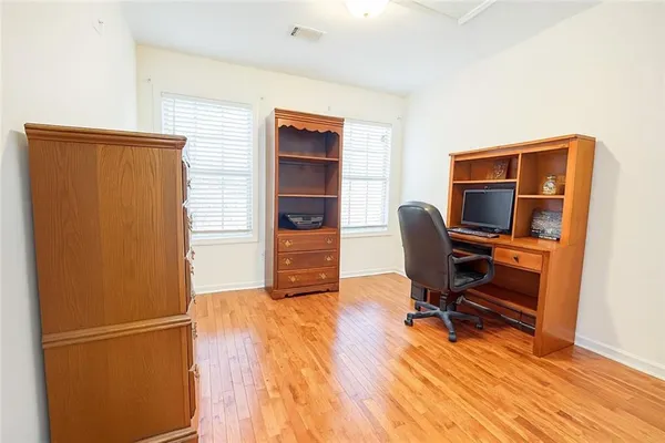 a view of a workspace with furniture and a window