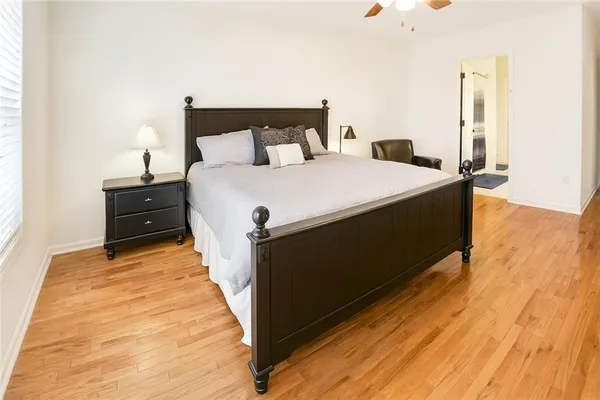 a bed sitting in a bedroom next to a window