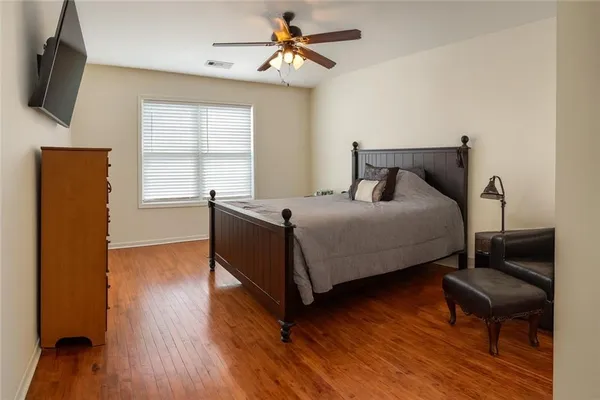 a bedroom with a bed and wooden floor