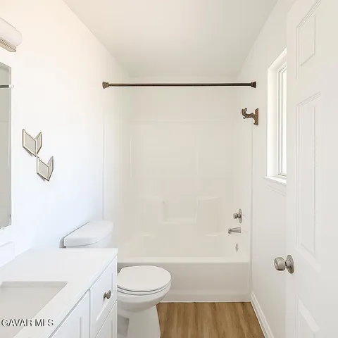 a bathroom with a shower a toilet and a sink