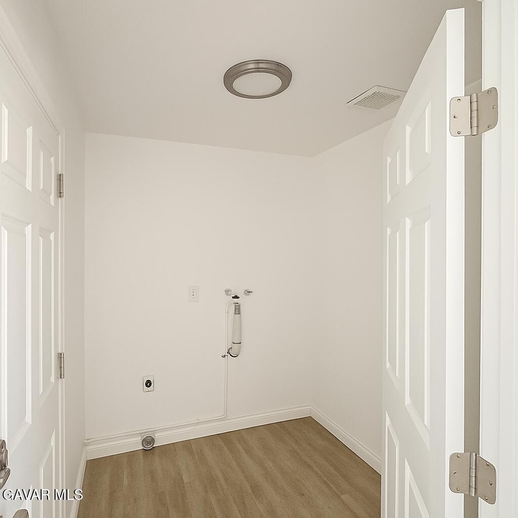 16549 Mossdale Avenue Lake Los Angeles, CA 93535 - Photo 17 of 23 a view of a room with wooden floor and white walls