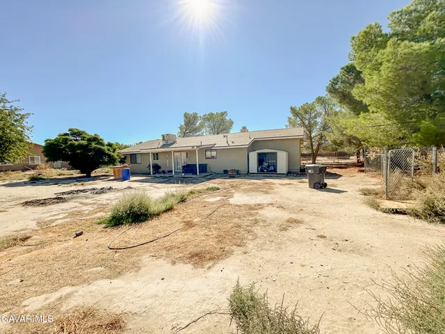 a front view of a building with a yard