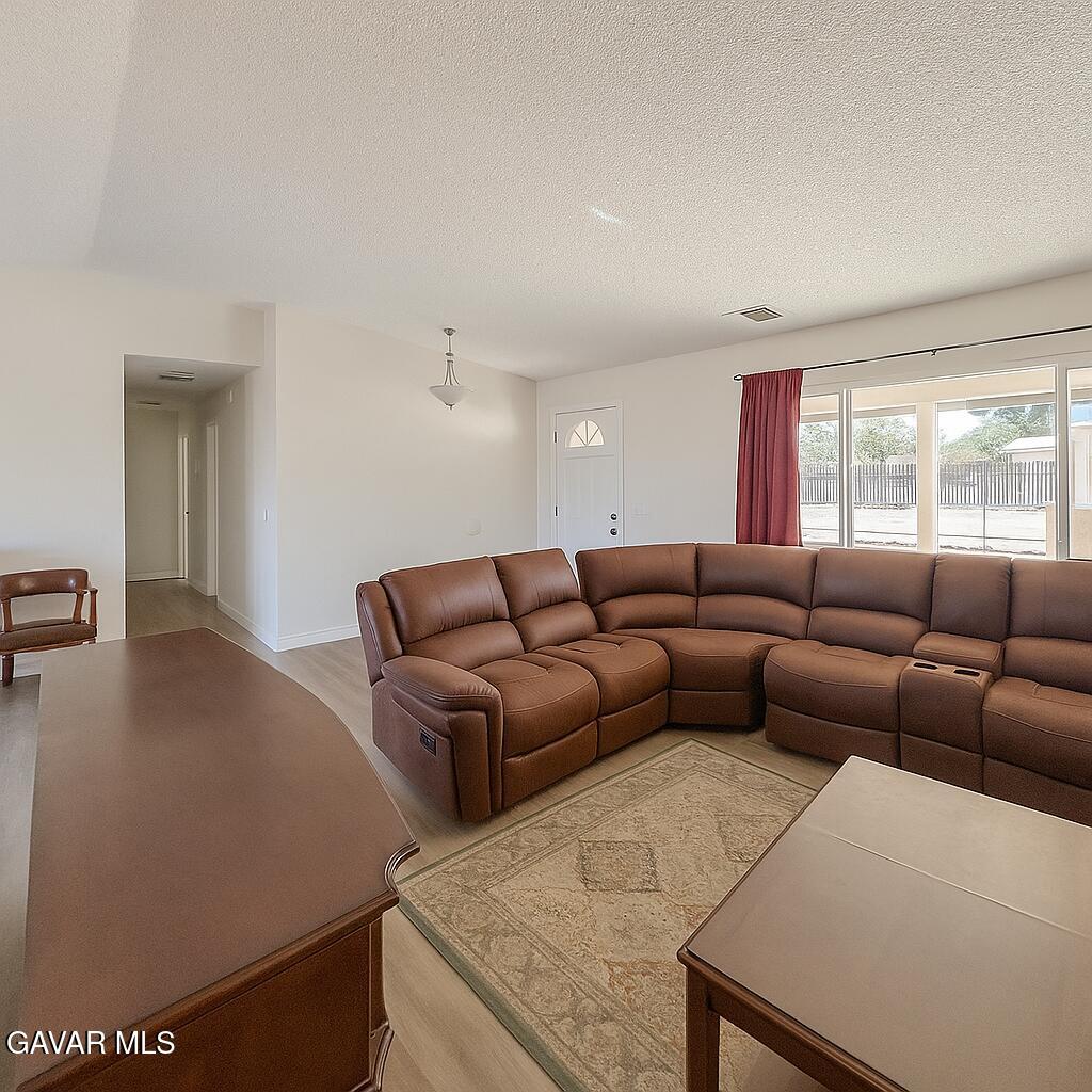 16549 Mossdale Avenue Lake Los Angeles, CA 93535 - Photo 3 of 23 a living room with furniture and a large window