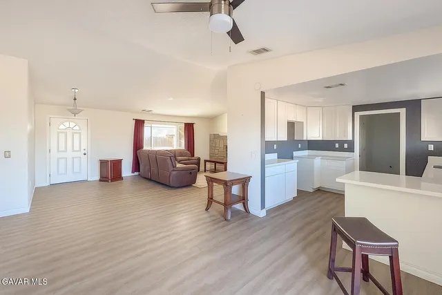 a living room with furniture and kitchen view