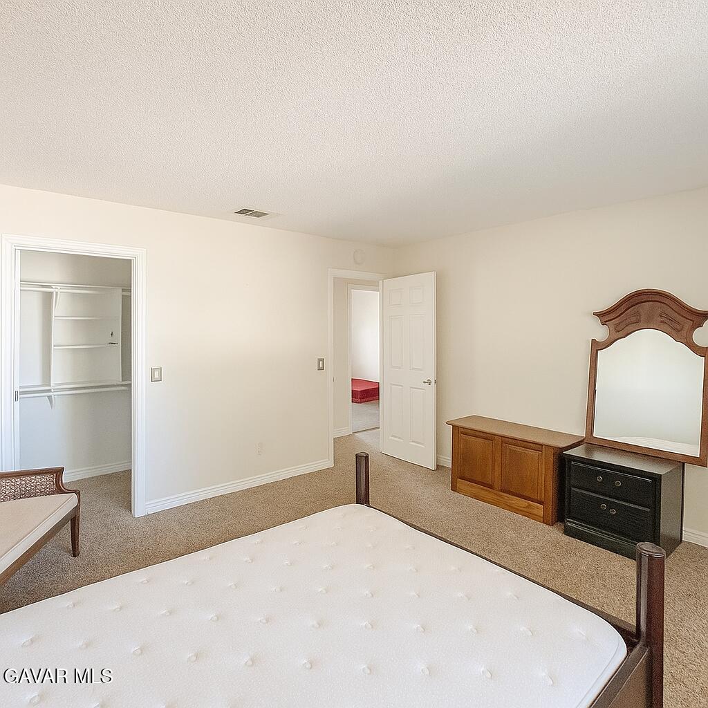 16549 Mossdale Avenue Lake Los Angeles, CA 93535 - Photo 7 of 23 a bedroom with a bed and a television