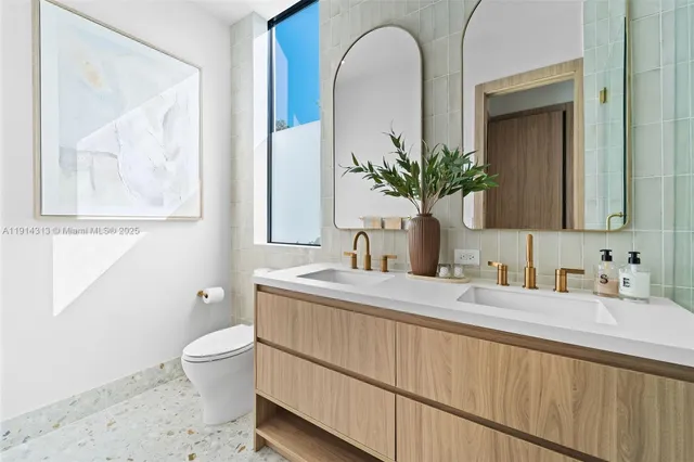 a bathroom with a toilet sink and mirror