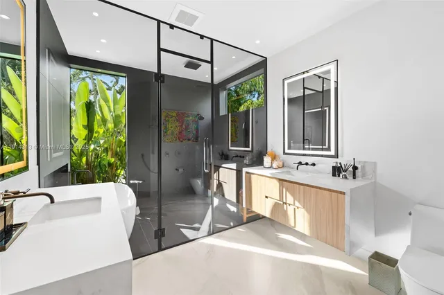 a bathroom with a tub sink and mirror
