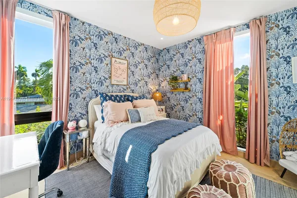 a bedroom with a bed and a painting on the wall