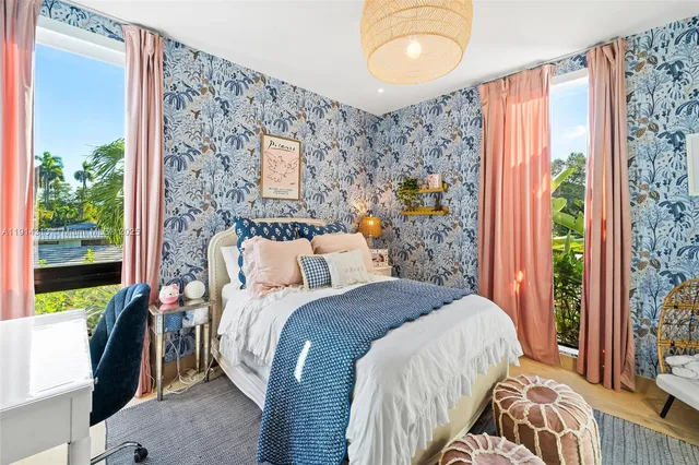 a bedroom with a bed and a painting on the wall