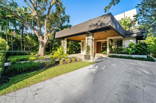 a view of a house with garden and pathway